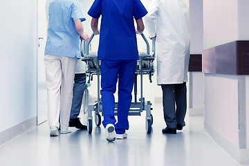 Image showing medics carrying hospital gurney to emergency room