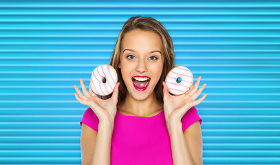 Image showing happy woman or teen girl with donuts
