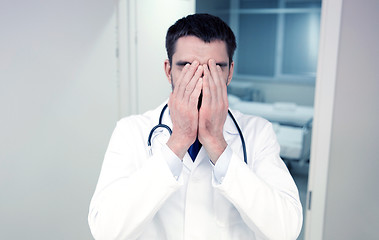 Image showing sad or crying male doctor at hospital ward