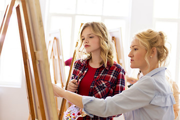 Image showing student and teacher with easel at art school