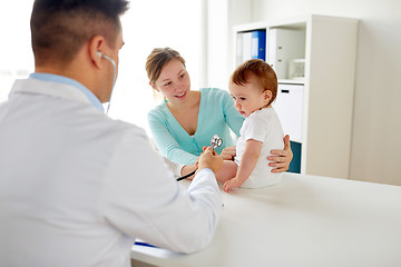 Image showing doctor with stethoscope listening baby at clinic