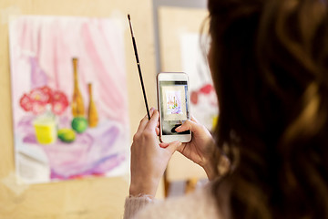 Image showing woman with painting on smartphone at art school