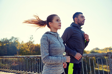 Image showing happy couple running outdoors