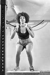 Image showing black female athlete is performing box jumps at gym