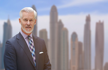 Image showing Senior businessman in front of the big city