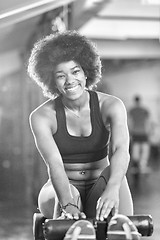 Image showing black woman doing sit ups at the gym