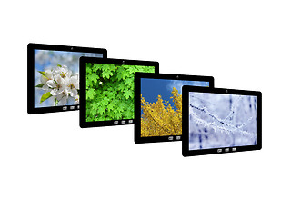 Image showing four tablet computers with images of seasons