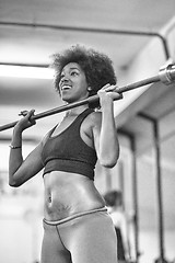 Image showing black woman lifting empty bar