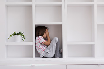 Image showing young boy posing on a shelf