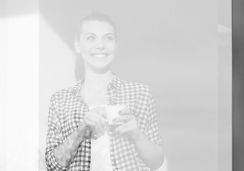 Image showing Portrait of young girl smiling and drinking coffe