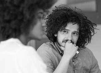 Image showing Businessman looking at his colleague at work