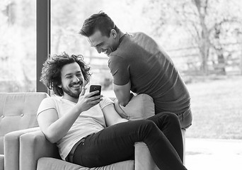 Image showing Two friends watching video