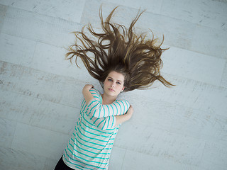 Image showing beautiful girl lying on floor