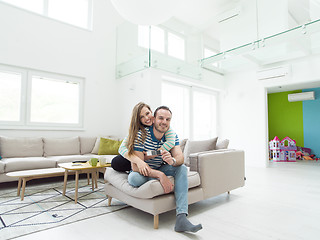 Image showing young handsome couple hugging on the sofa