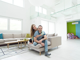 Image showing young handsome couple hugging on the sofa