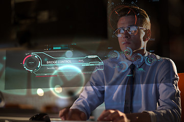 Image showing man working on computer in dark office