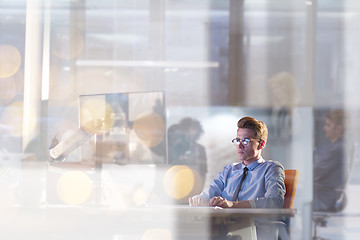 Image showing man working on computer in dark office