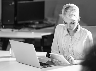 Image showing Businesswoman using tablet at work