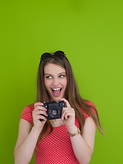 Image showing smilling girl taking photo on a retro camera