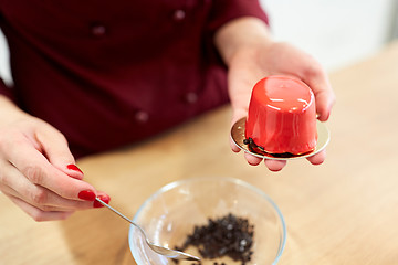 Image showing chef decorating mirror glaze cakes at pastry shop