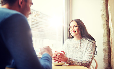 Image showing happy couple drinking tea and coffee at cafe