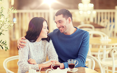 Image showing happy couple drinking tea at restaurant