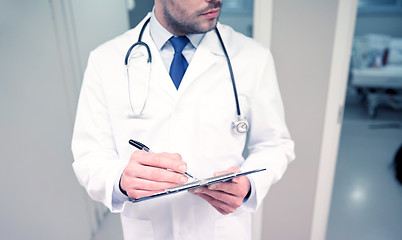 Image showing close up of doctor with clipboard at hospital