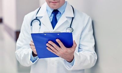 Image showing close up of doctor with clipboard at hospital