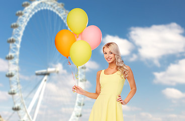 Image showing happy woman with air balloons over ferris wheel