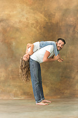Image showing Man hugging her teenage daughter at brown