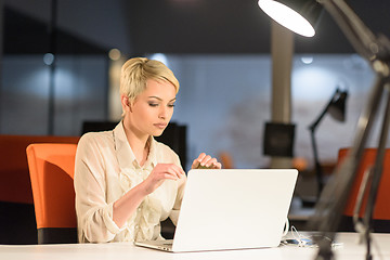 Image showing woman working on laptop in night startup office