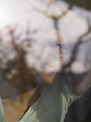 Image showing young man drinking morning coffee by the window