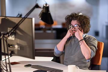 Image showing man working on computer in dark startup office