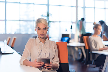 Image showing woman working on digital tablet in night office