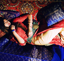 Image showing young pretty asian girl in bright colored interior