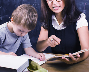 Image showing little cute boy with teacher in classroom