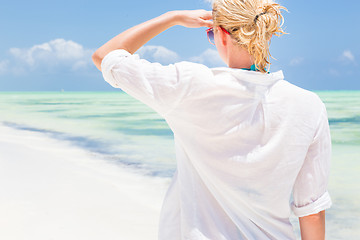 Image showing Happy woman enjoying, relaxing joyfully in summer on tropical beach.