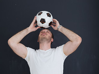 Image showing man playing with soccer ball isolated over grey