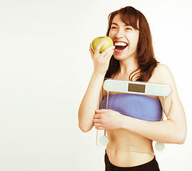 Image showing portrait of young smiling girl with green apple and scales