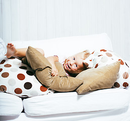 Image showing little cute blonde girl playing at home with pillows