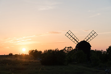 Image showing Sunset by an old wooden windmill