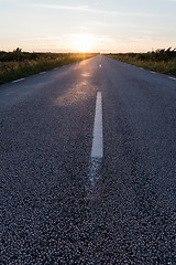 Image showing Sunlit asphalt road from low perspective