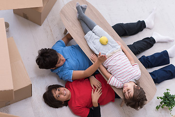 Image showing boys with cardboard boxes around them top view