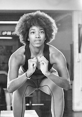 Image showing black female athlete is performing box jumps at gym