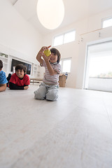 Image showing boys having fun with an apple on the floor