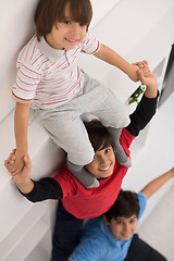 Image showing young boys posing line up piggyback top view