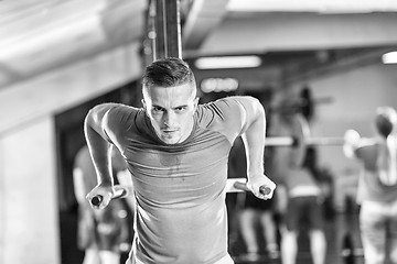 Image showing man doing exercises parallel bars