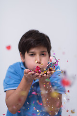 Image showing kid blowing confetti