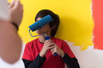 Image showing young boy painter with paint roller