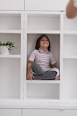 Image showing young boy posing on a shelf